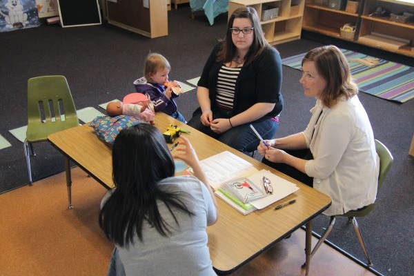 Meeting with parent in a classroom.