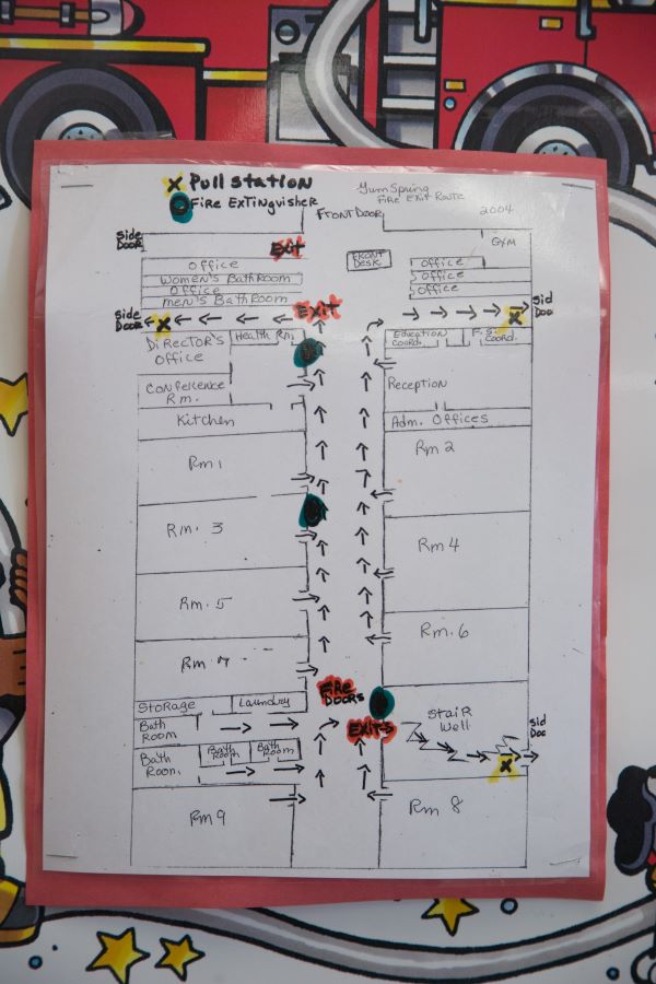 A well marked exit map of building showing hallways, doors, fire extinguishers and more.